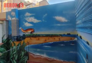 mural happy people patio playa skyline barcelona pez